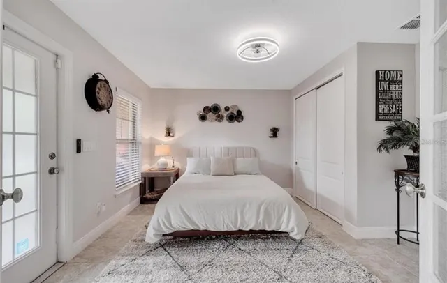 a bedroom with a bed and a chandelier