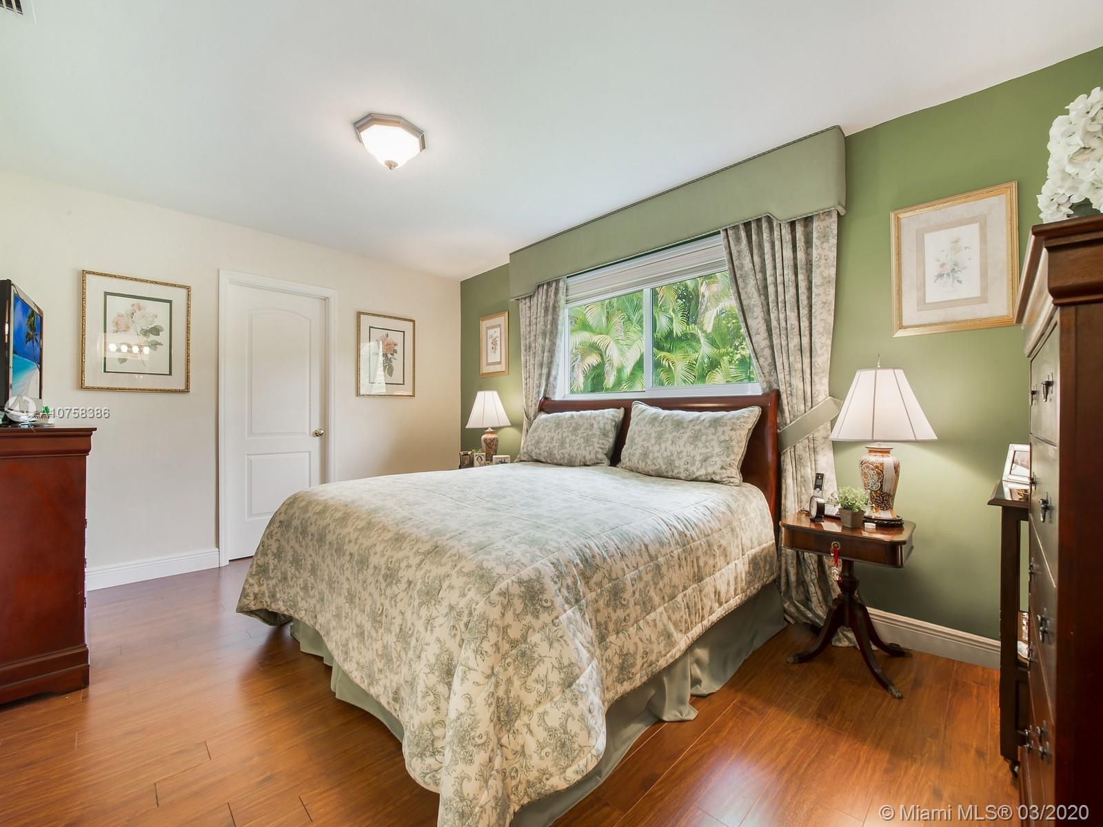 6701 Southwest 49th Terrace Miami, FL 33155 - Photo 11 of 24 a bed room with a bed and a lamp