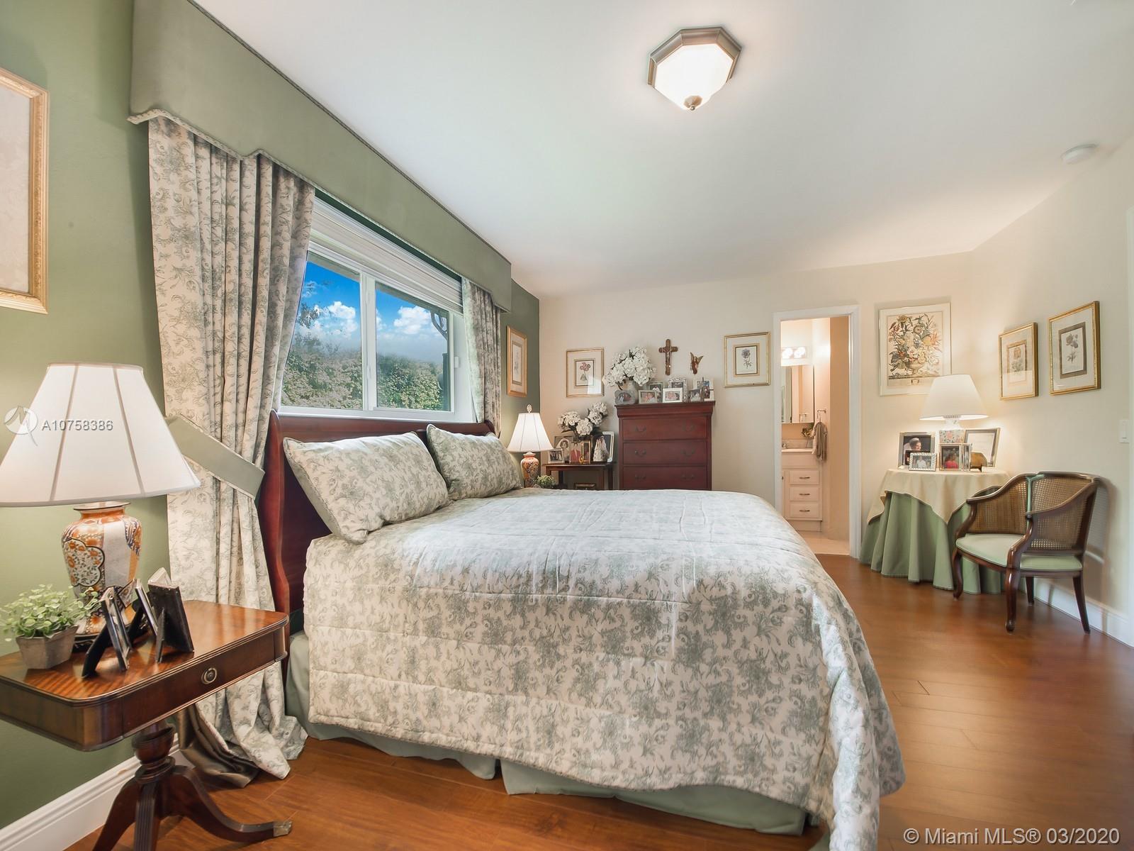 6701 Southwest 49th Terrace Miami, FL 33155 - Photo 12 of 24 a spacious bedroom with a bed and wooden floor