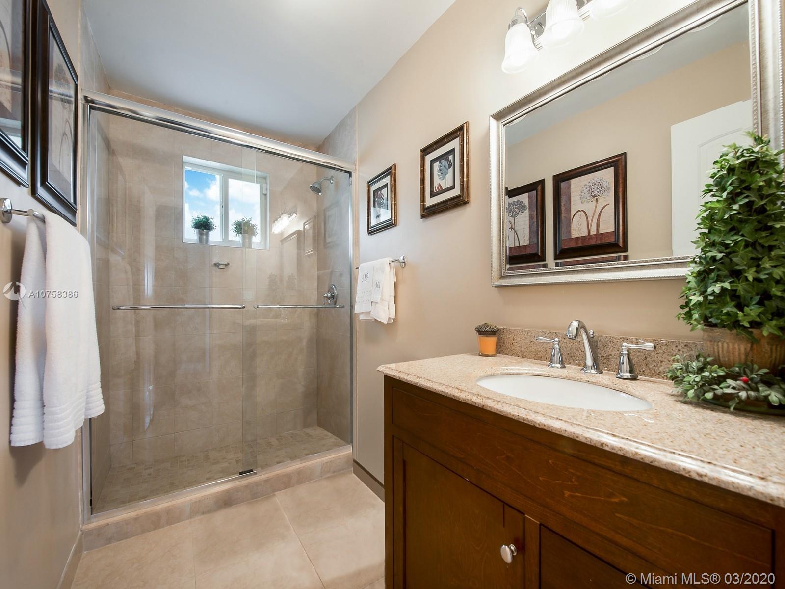 6701 Southwest 49th Terrace Miami, FL 33155 - Photo 15 of 24 a bathroom with a sink a mirror and a shower