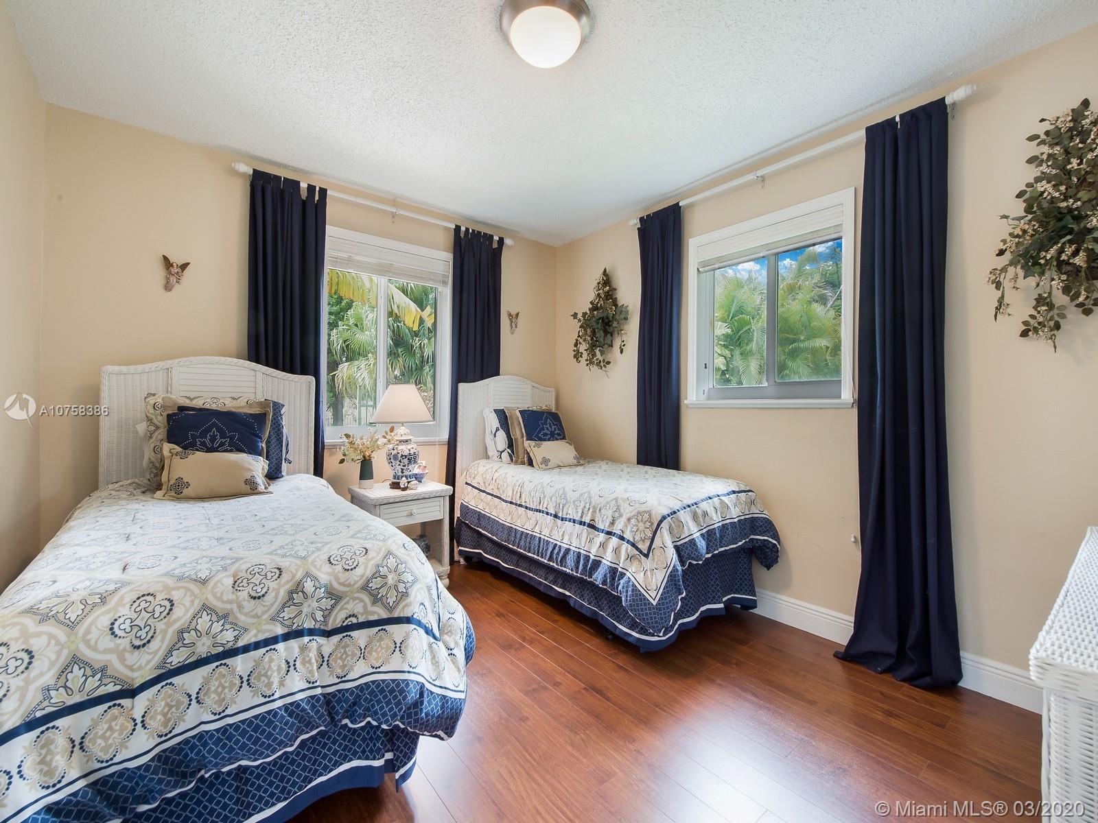 6701 Southwest 49th Terrace Miami, FL 33155 - Photo 16 of 24 a bedroom with a large bed and a window