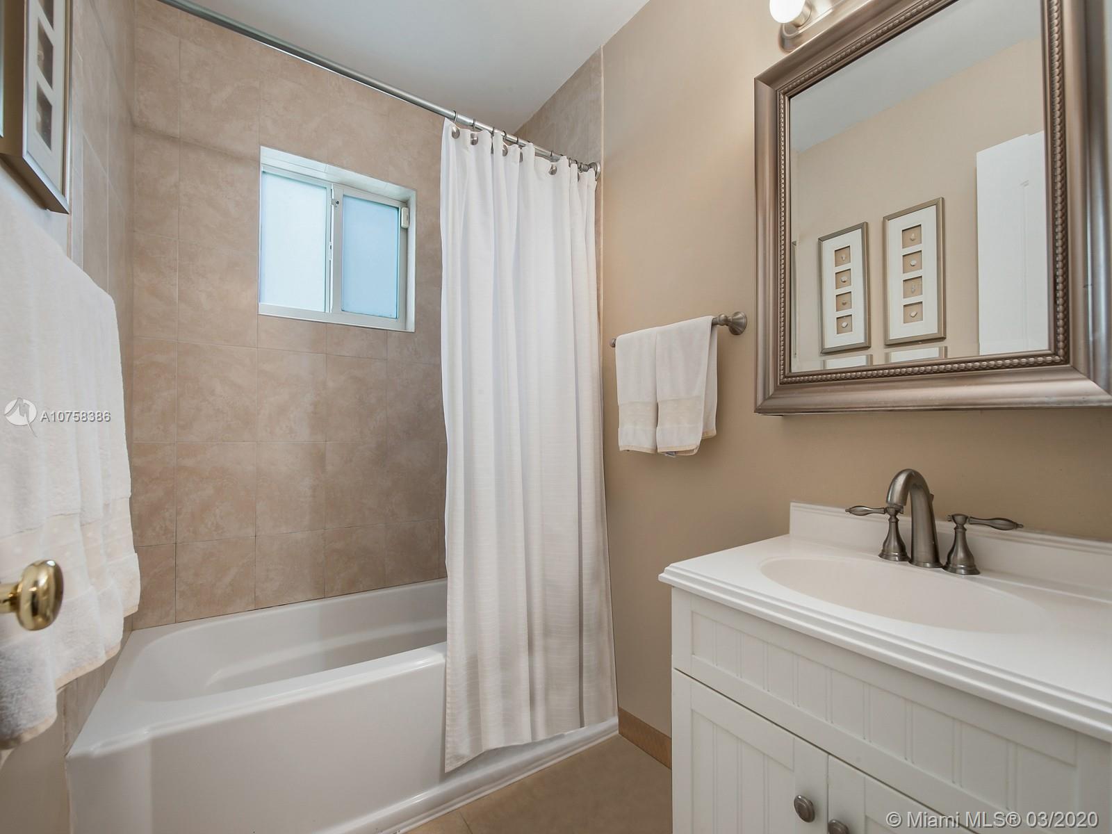 6701 Southwest 49th Terrace Miami, FL 33155 - Photo 17 of 24 a bathroom with a shower a sink and a mirror