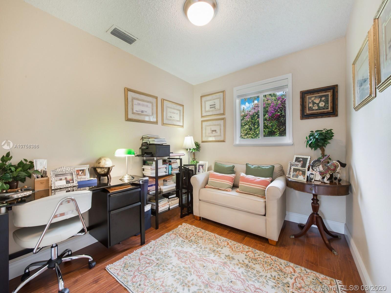 6701 Southwest 49th Terrace Miami, FL 33155 - Photo 18 of 24 a living room with furniture a rug and a window