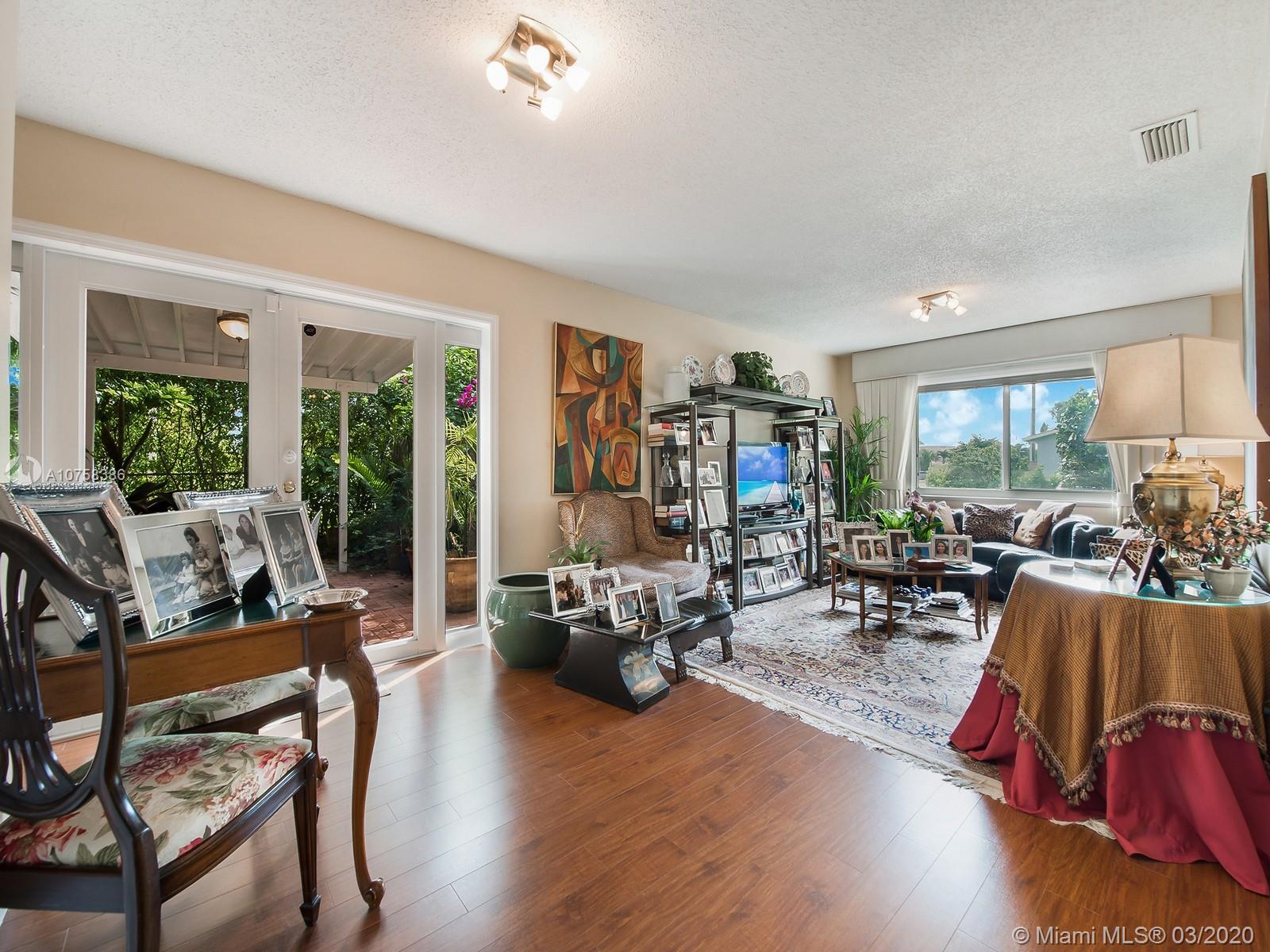 6701 Southwest 49th Terrace Miami, FL 33155 - Photo 6 of 24 a living room with furniture floor to ceiling window and wooden floor