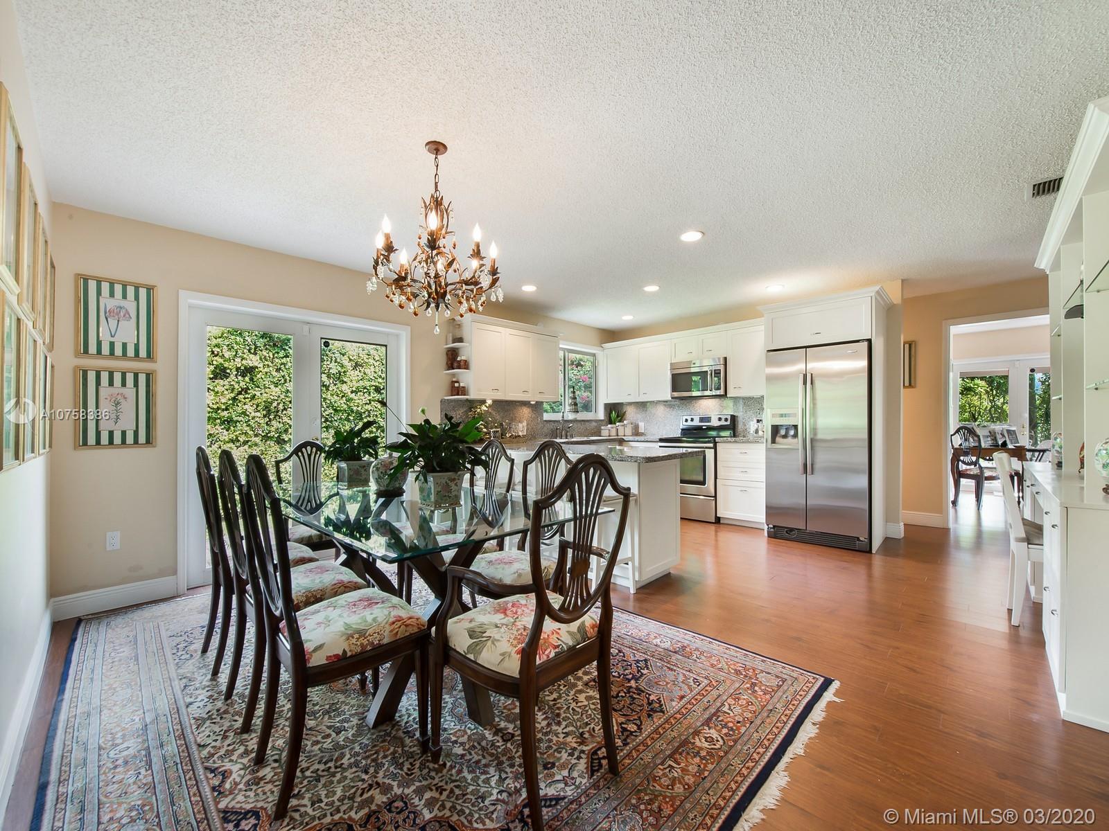 6701 Southwest 49th Terrace Miami, FL 33155 - Photo 9 of 24 a dining room with furniture and wooden floor