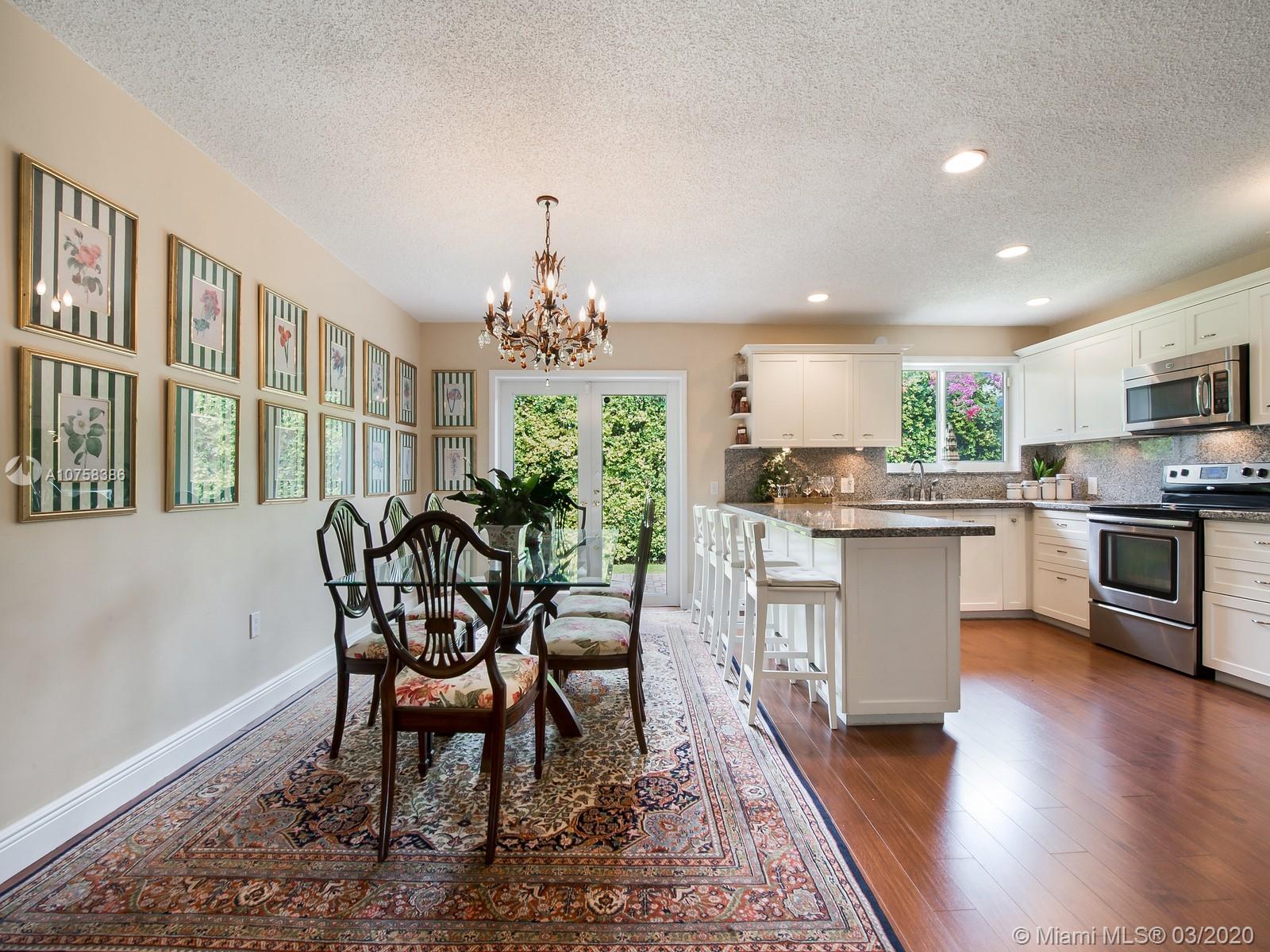 6701 Southwest 49th Terrace Miami, FL 33155 - Photo 10 of 24 a view of a dining room with furniture and chandelier