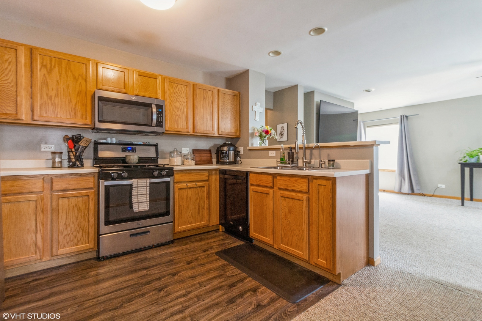 2029 Frantum Road, Unit 2029 Sycamore, IL 60178 - Photo 5 of 18 a kitchen with stainless steel appliances granite countertop a stove top oven a sink dishwasher and white cabinets with wooden floor