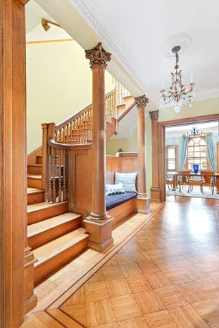 a view of a balcony with chairs and a potted plant