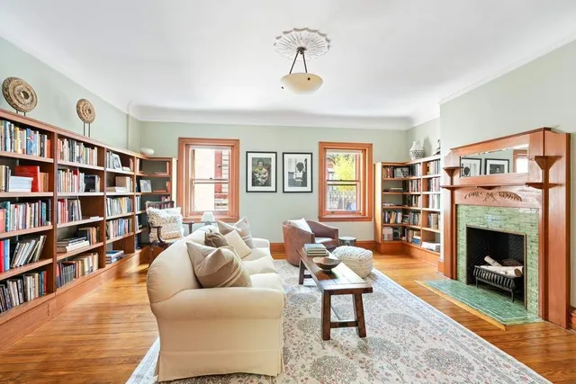 a spacious bedroom with a large bed and a chandelier