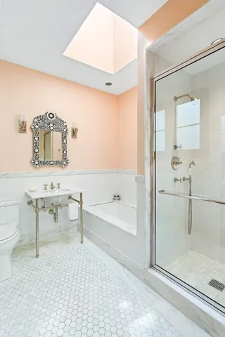 a bathroom with a sink toilet and shower