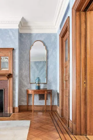 a view of staircase with railing and a chandelier