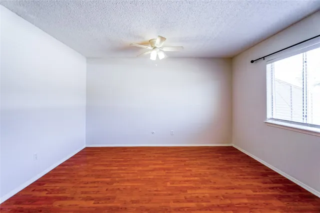 a view of a room with wooden floor