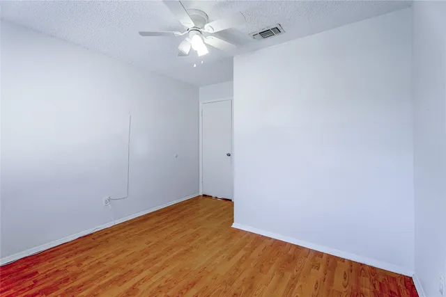 a view of a two chairs in the patio with a small yard