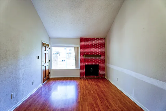 a view of room with window and hardwood floor