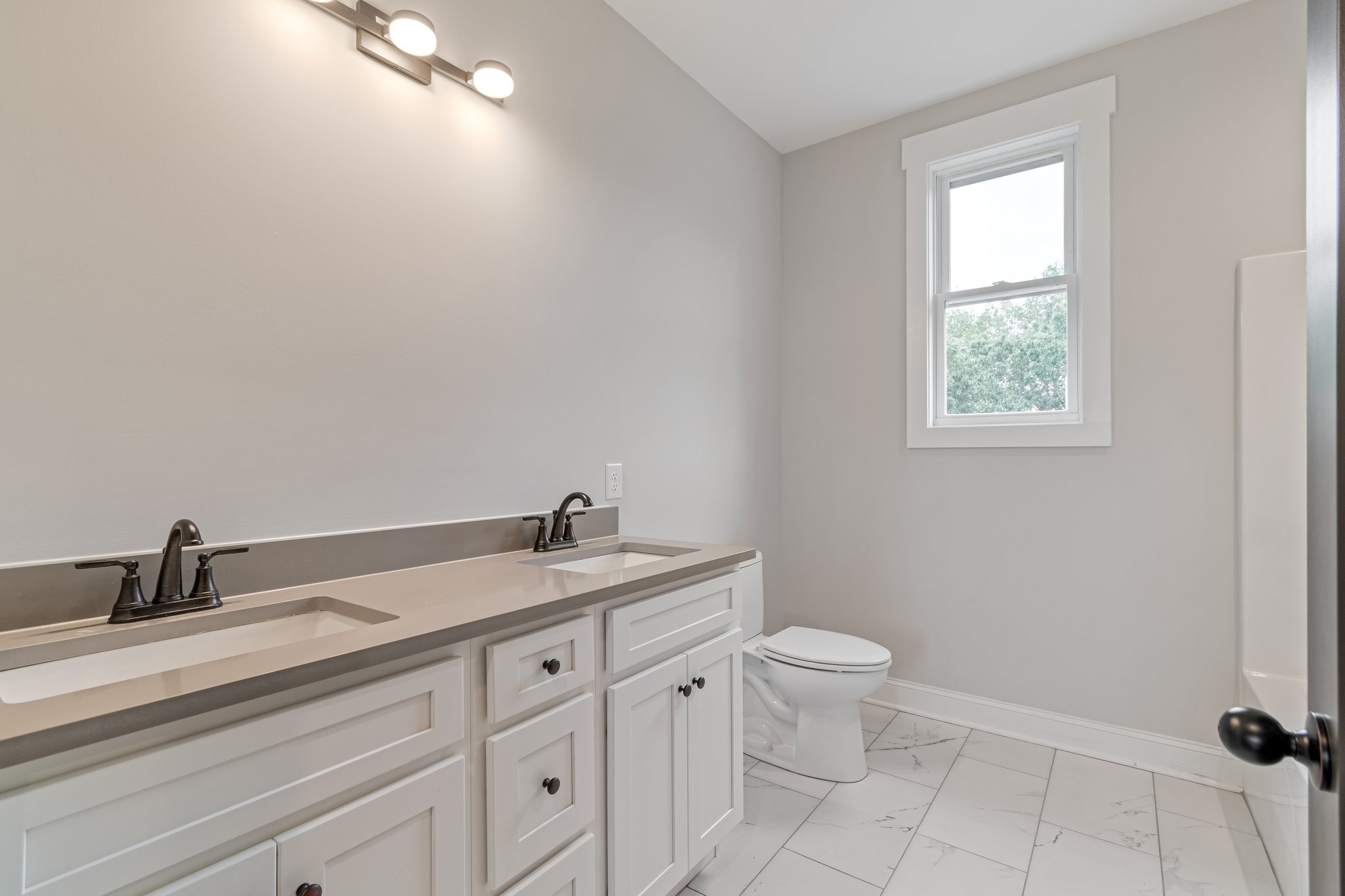 2675 Monte Murrey Road Lewisburg, TN 37091 - Photo 40 of 61 a bathroom with a granite countertop sink a toilet and a window