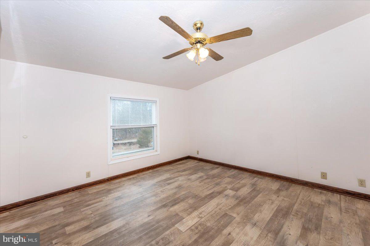 105 Relative Way Falling Waters, WV 25419 - Photo 11 of 42 an empty room with wooden floor fan and windows