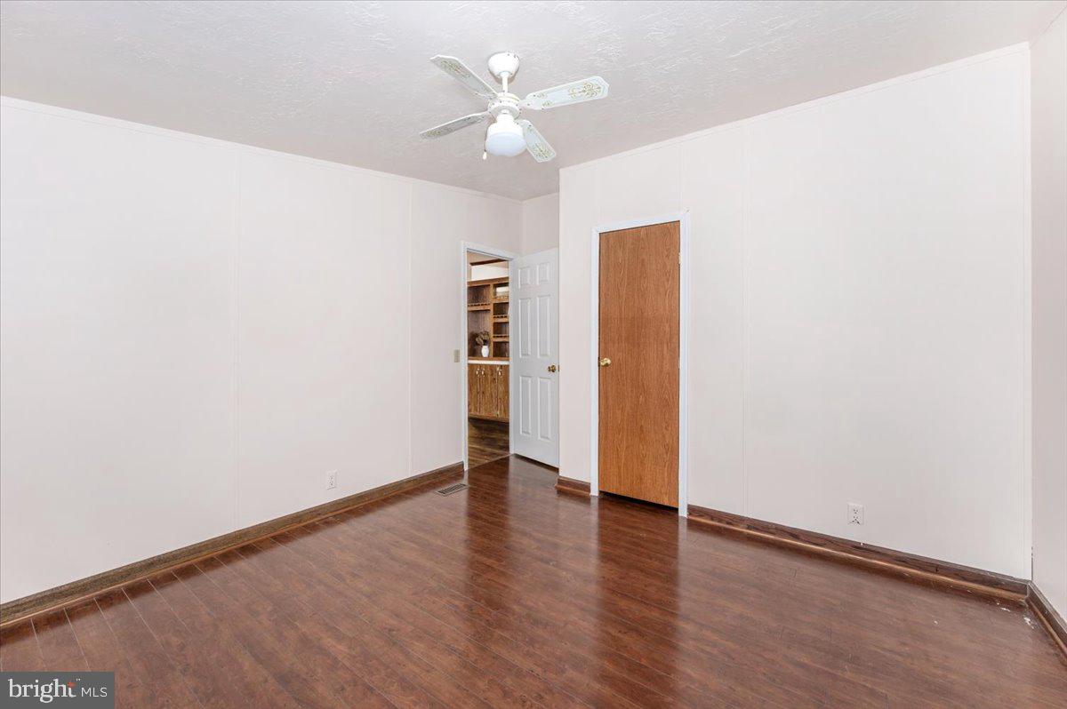 105 Relative Way Falling Waters, WV 25419 - Photo 20 of 42 an empty room with wooden floor and ceiling fan