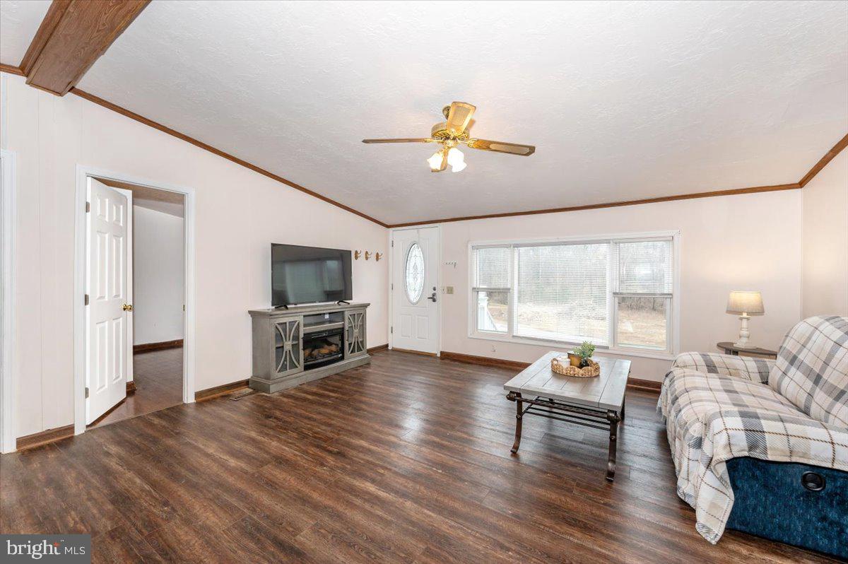105 Relative Way Falling Waters, WV 25419 - Photo 2 of 42 a living room with furniture a flat screen tv and a fireplace