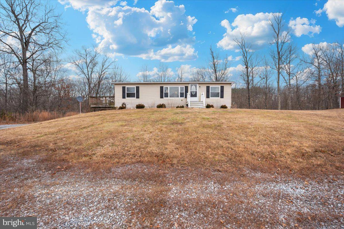 105 Relative Way Falling Waters, WV 25419 - Photo 32 of 42 a front view of a house with a yard and trees