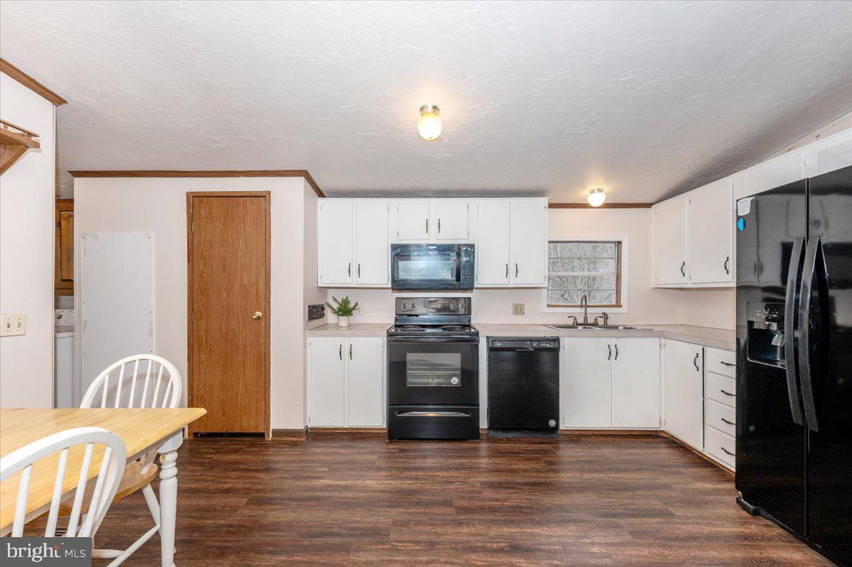 105 Relative Way Falling Waters, WV 25419 - Photo 6 of 42 a kitchen with stainless steel appliances granite countertop a refrigerator a stove top oven a sink dishwasher and white cabinets with wooden floor