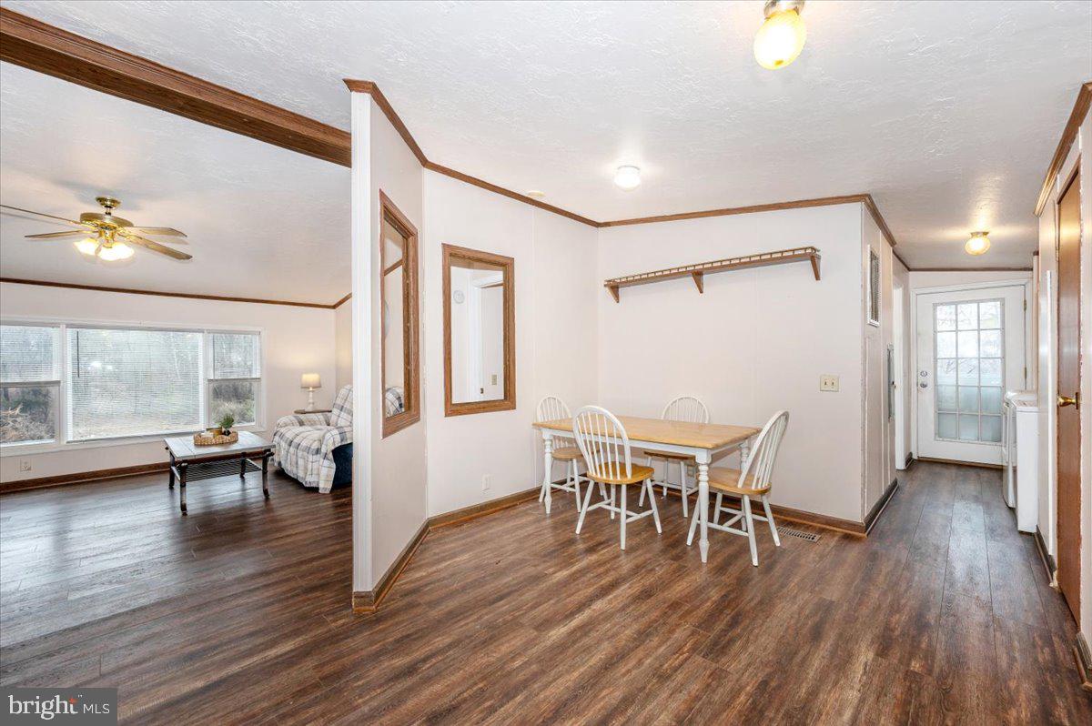 105 Relative Way Falling Waters, WV 25419 - Photo 9 of 42 a dining room with wooden floor a chandelier a glass table and chairs