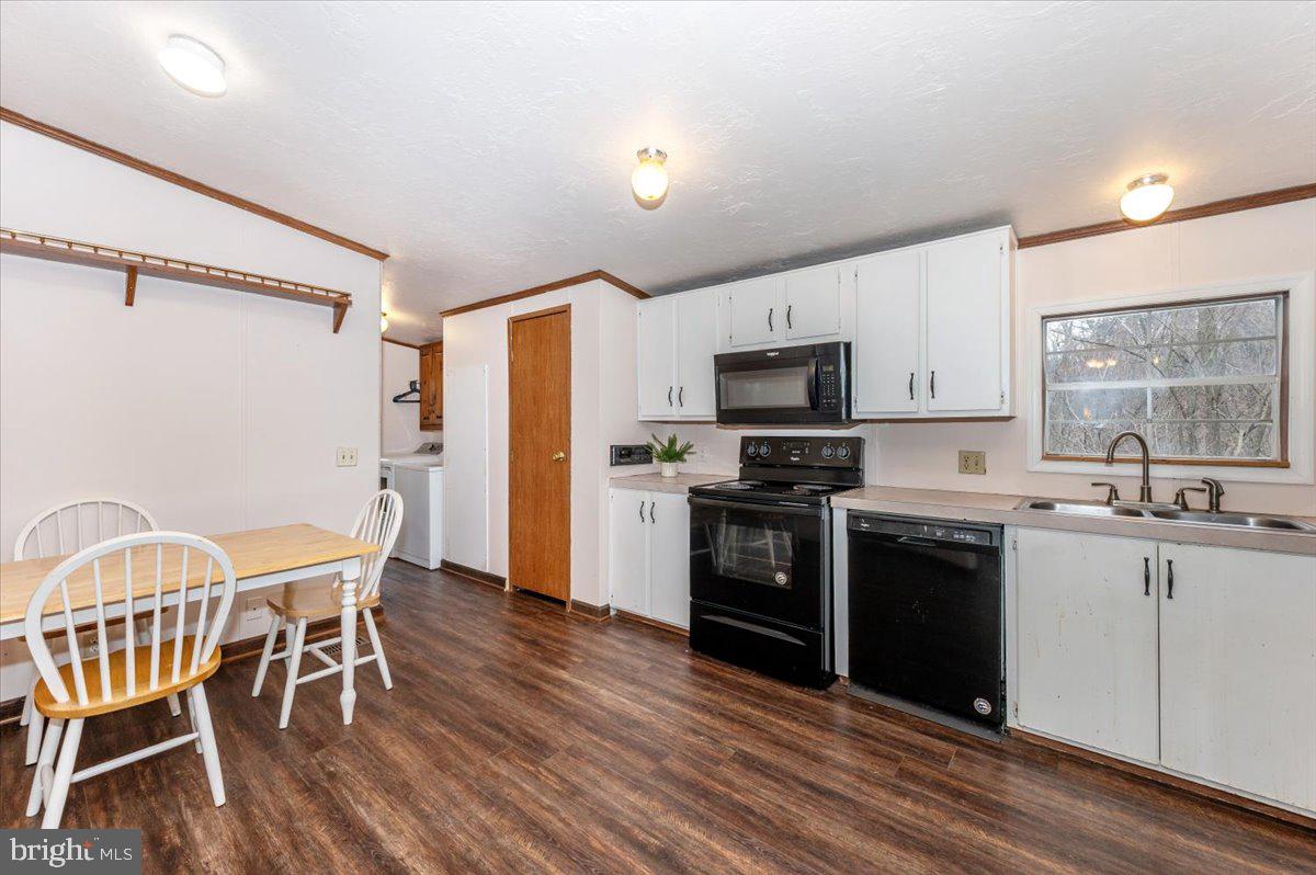 105 Relative Way Falling Waters, WV 25419 - Photo 10 of 42 a kitchen with stainless steel appliances granite countertop a stove top oven a sink dishwasher a dining table and chairs with wooden floor