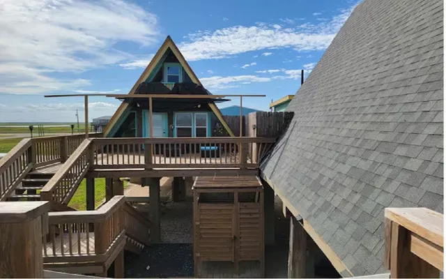 a view of a roof deck with chair and wooden floor
