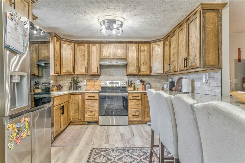 242 Brewer Road Kingston, GA 30145 - Photo 1 of 1 a kitchen with stainless steel appliances granite countertop lots of counter top space and wooden floor