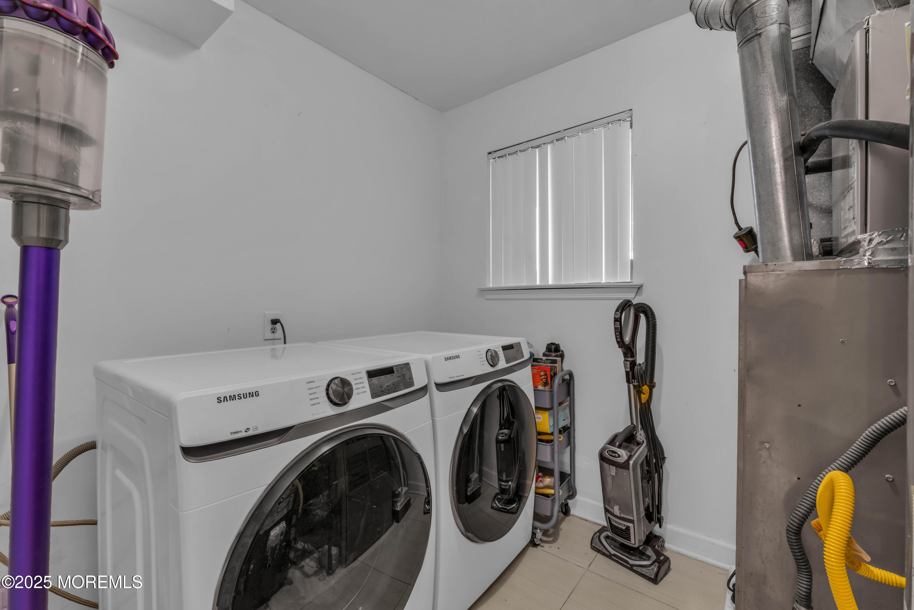 38 Kiwi Loop Howell, NJ 07731 - Photo 11 of 32 a view of storage and utility room with washer and dryer