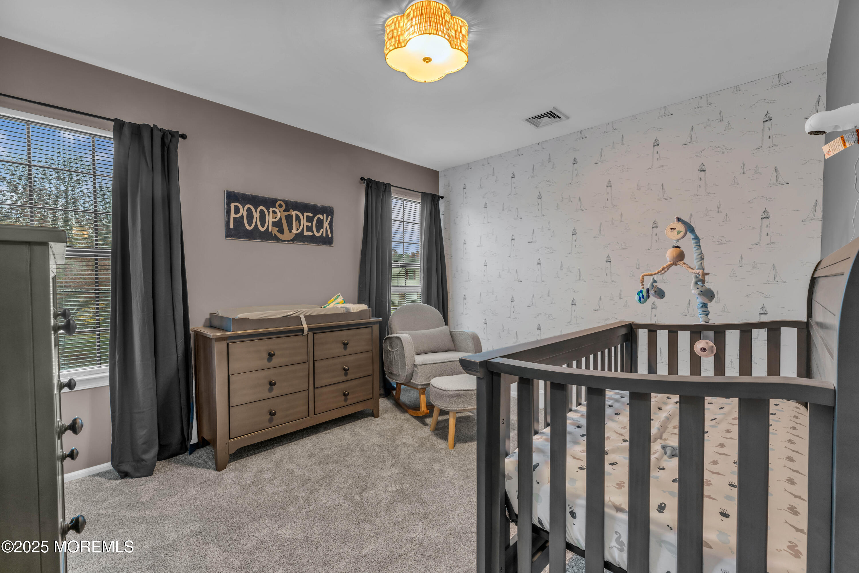 38 Kiwi Loop Howell, NJ 07731 - Photo 20 of 32 a bedroom with a baby bed a chandelier and closet