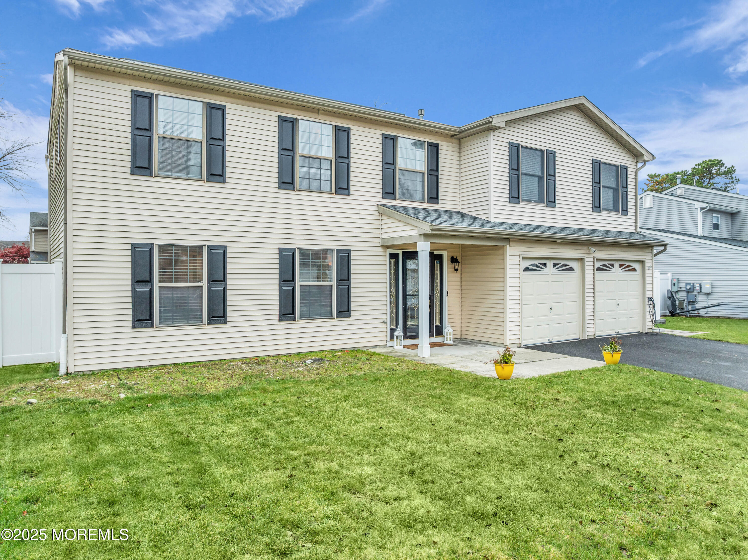 38 Kiwi Loop Howell, NJ 07731 - Photo 32 of 32 a front view of a house with a yard and garage