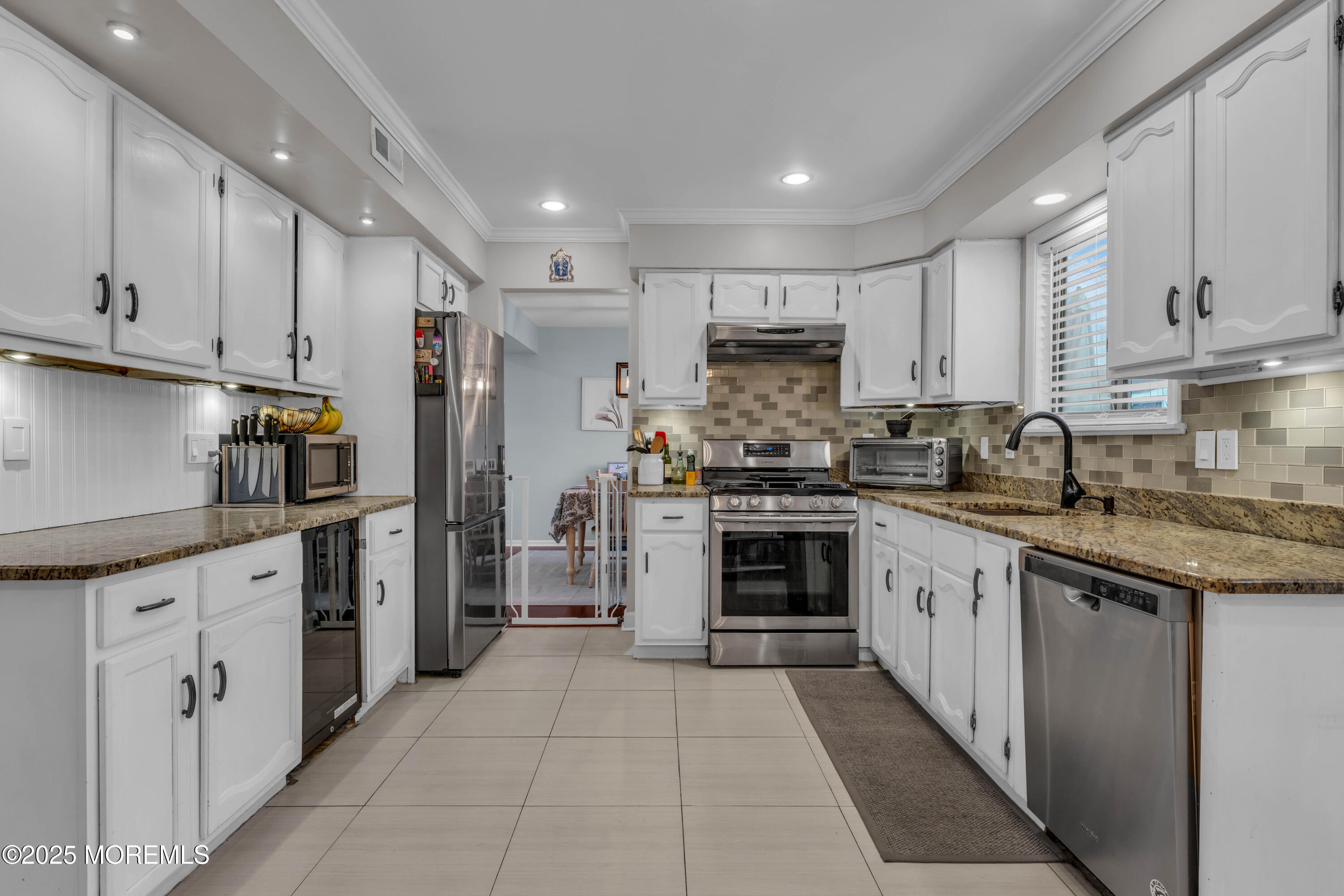 38 Kiwi Loop Howell, NJ 07731 - Photo 6 of 32 a kitchen with stainless steel appliances granite countertop a refrigerator sink and cabinets