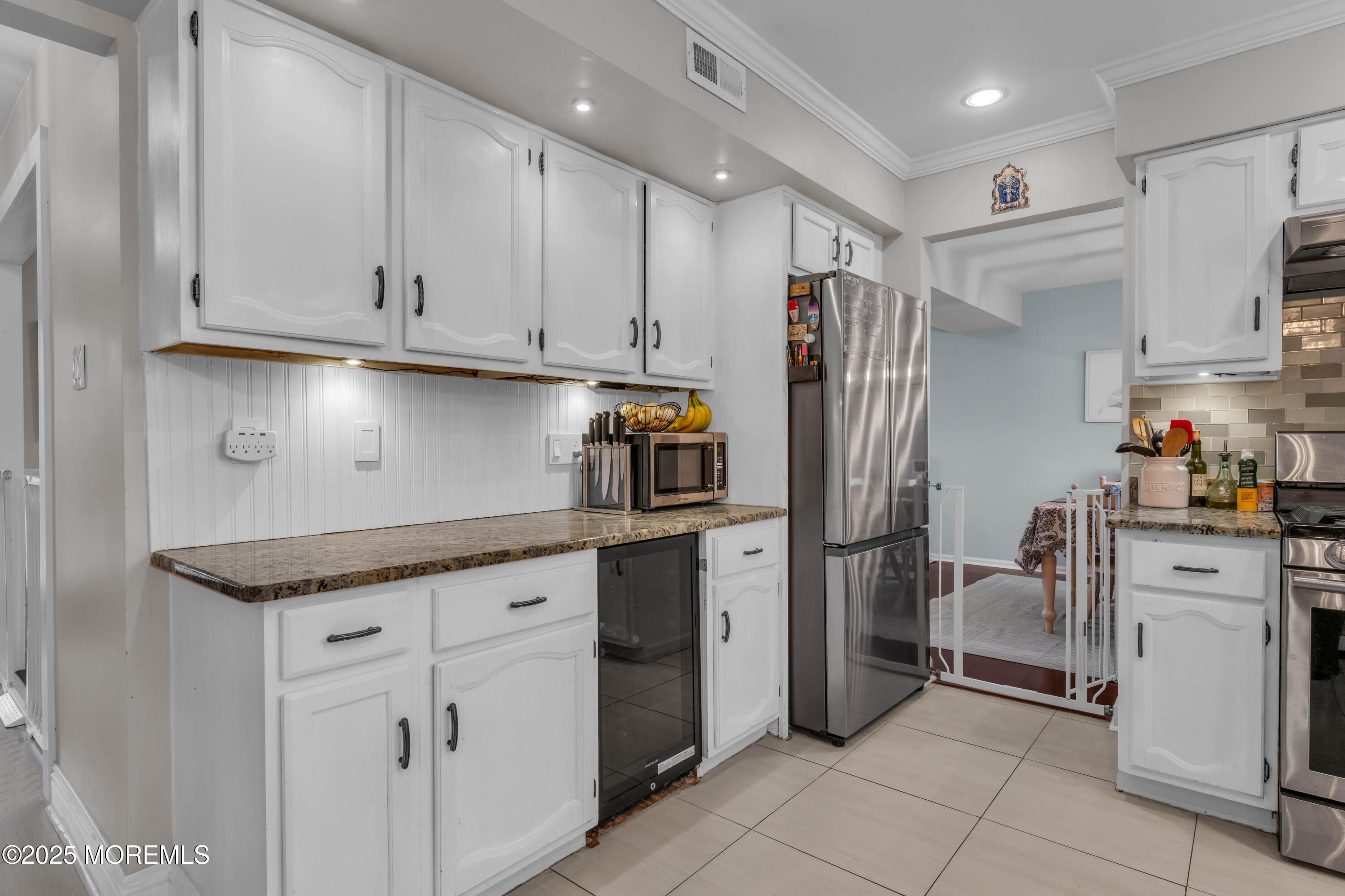 38 Kiwi Loop Howell, NJ 07731 - Photo 7 of 32 a kitchen with stainless steel appliances granite countertop a refrigerator sink and cabinets