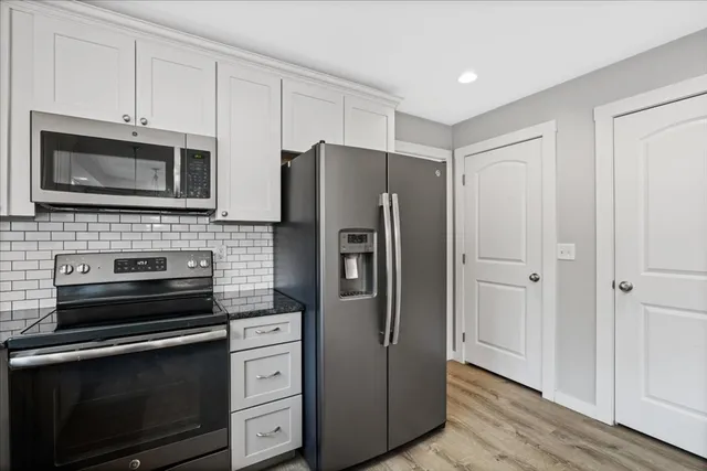 a kitchen with stainless steel appliances a refrigerator microwave and sink