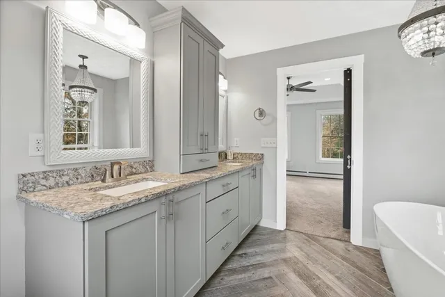 a bathroom with a granite countertop sink and a mirror