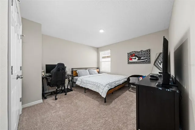 a bedroom with a bed and a desk