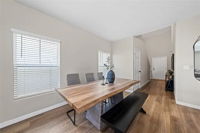 a view of a dining room with furniture and wooden floor