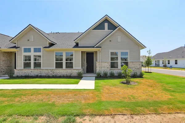 a front view of a house with a yard and porch