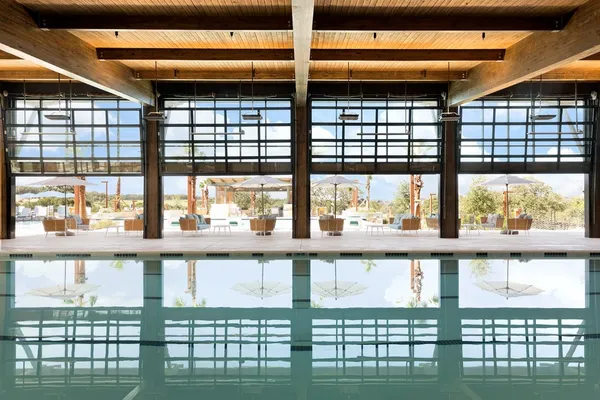 swimming pool view with a seating space and garden view
