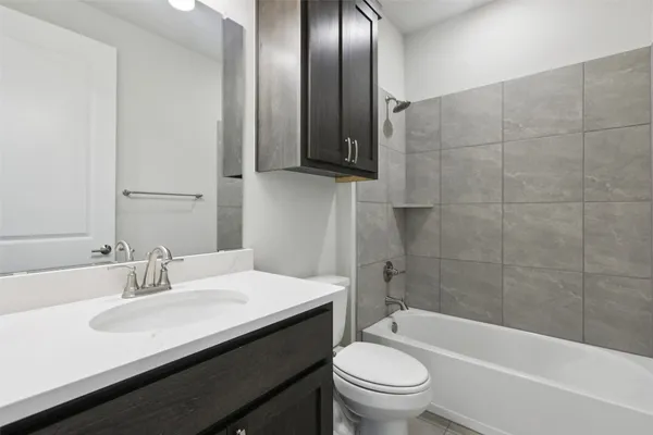 a large kitchen with kitchen island a sink dishwasher a refrigerator and a stove with wooden floor