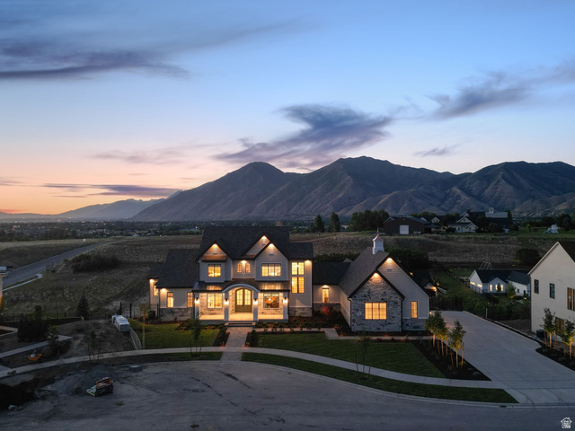 115 East Hidden Ridge Lane, Unit 42 Mapleton, UT 84664 - Photo 97 of 103 Grand residence featuring a stone and stucco exterior, prominent front porch, and extensive landscape lighting