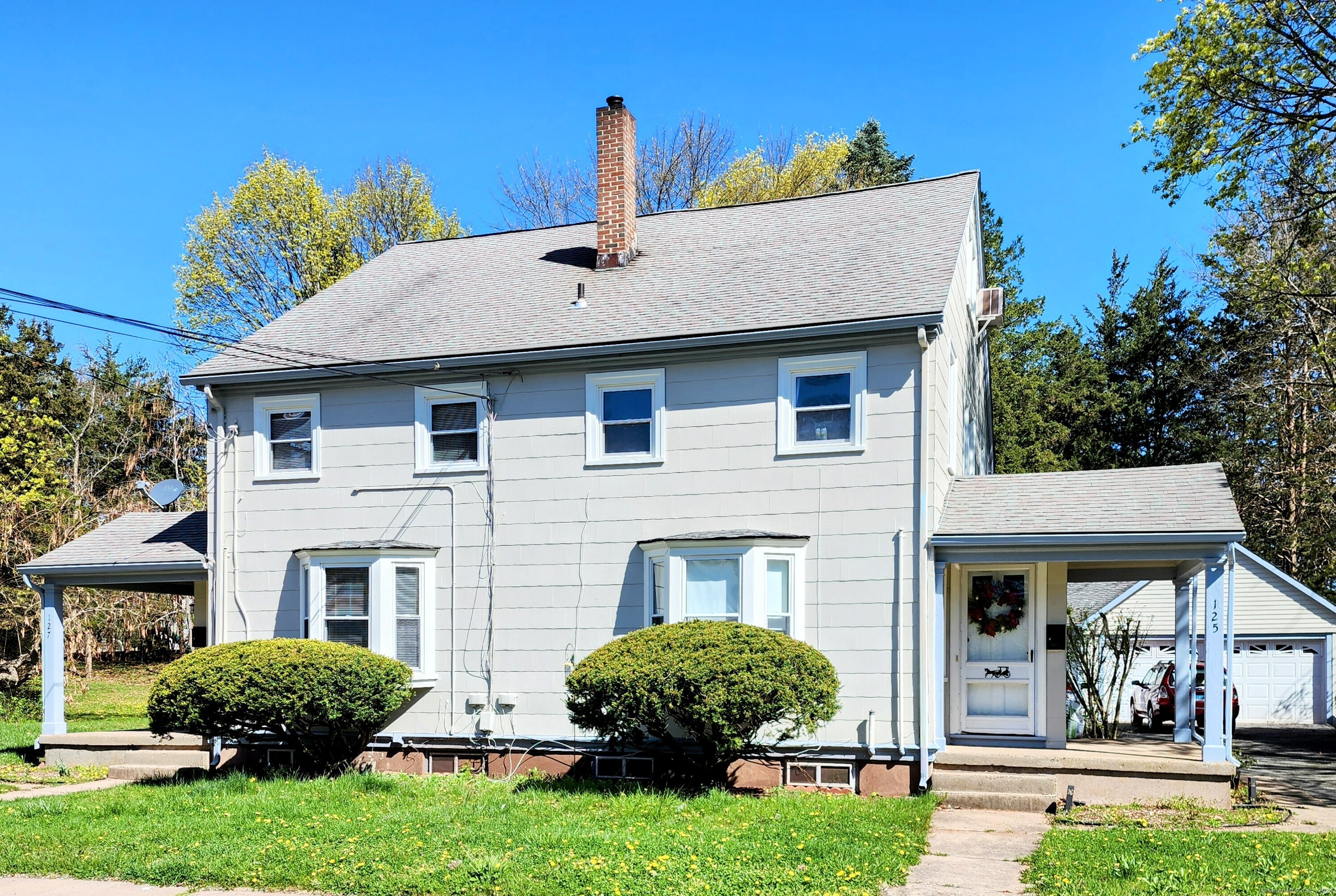 127 West Street Manchester, CT 06040 - Photo 1 of 1 a front view of a house with a garden and plants