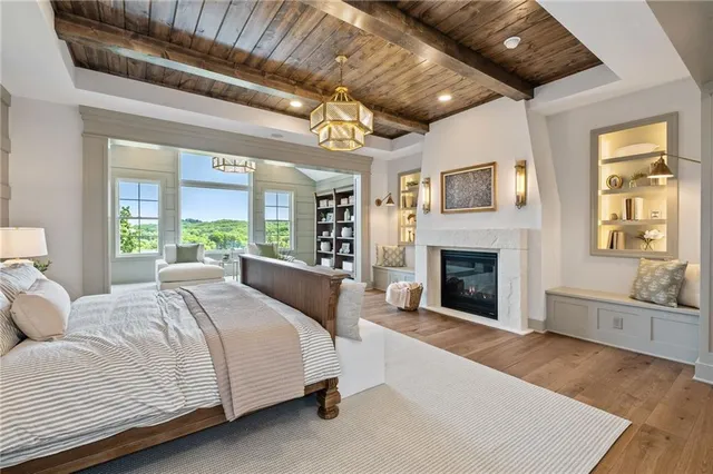 a spacious bedroom with a large bed and a fireplace