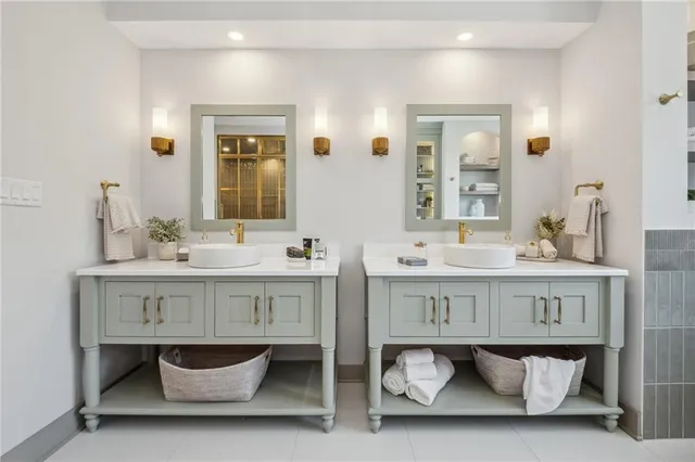 a bathroom with a double vanity sink a mirror and a bathtub