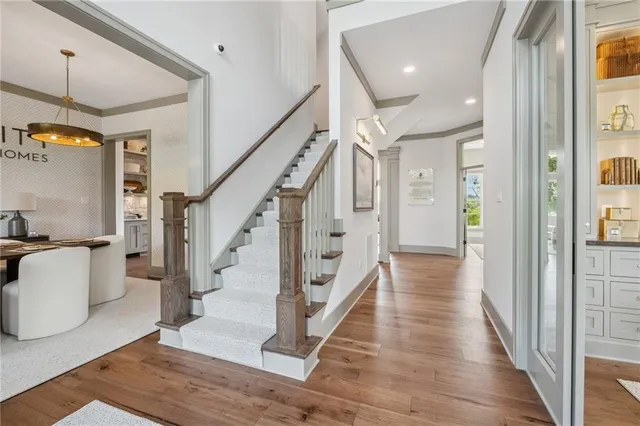 a view of a hallway view with living room and stairs