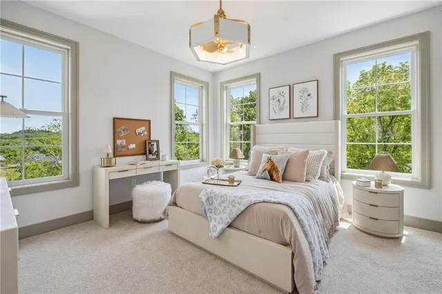 a bedroom with a bed and a large window