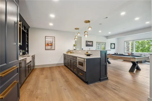 a large white kitchen with a large window