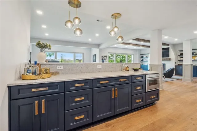 a view of a sink and a refrigerator