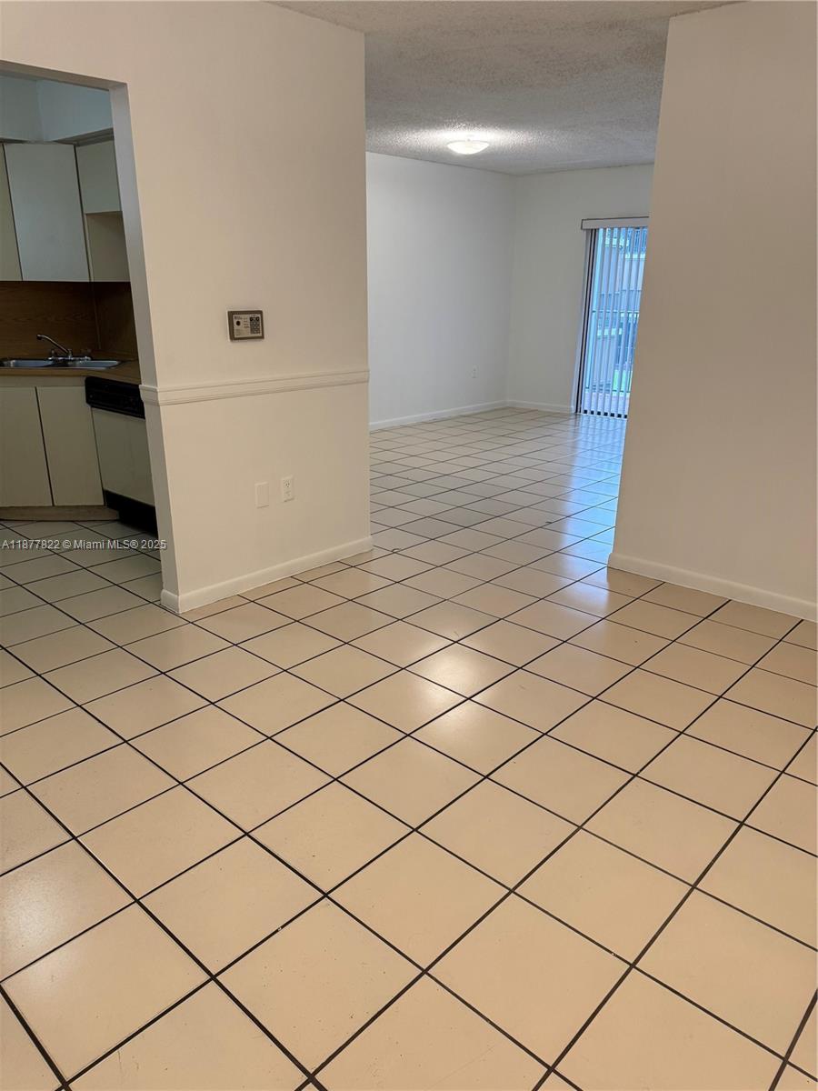5765 West 25th Court, Unit 206 Hialeah, FL 33016 - Photo 2 of 12 a view of an empty room and wooden floor