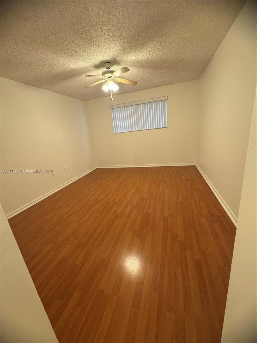 5765 West 25th Court, Unit 206 Hialeah, FL 33016 - Photo 9 of 12 wooden floor in an empty room